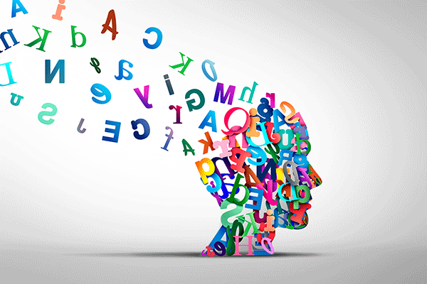 A stock image graphic of a human head made of multi-colored letters. The letters are floating away from the top of the head toward the upper-right corner. 